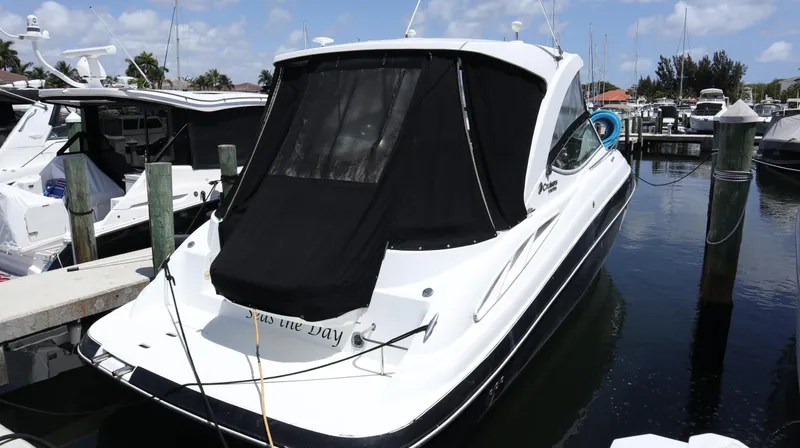 Slide: The Image of 2012 Cruisers Yachts 350 Express docked at marina, rear view with black cover. - 42