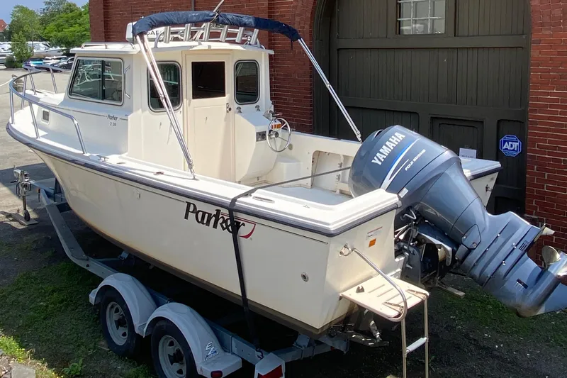 Slide: The Image of 2009 Parker 2120 Sport Cabin boat with Yamaha outboard motor on trailer. - 1