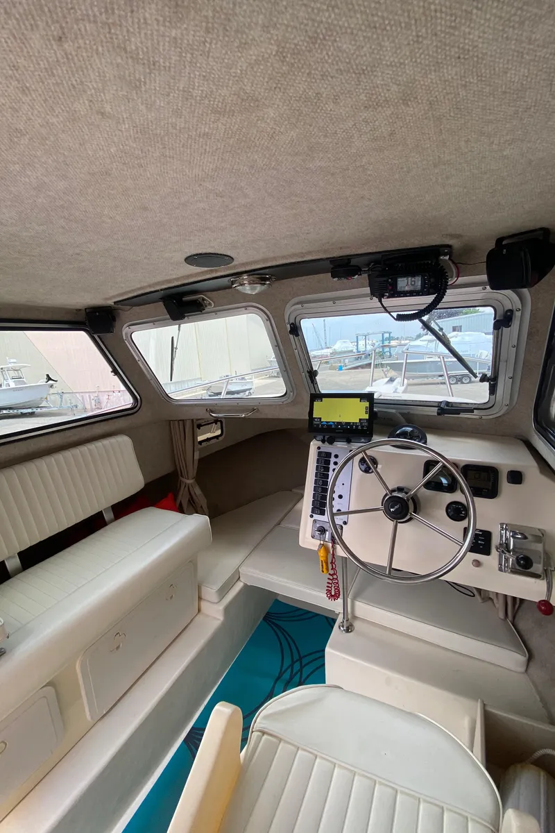 Slide: The Image of 2009 Parker 2120 Sport Cabin interior with steering wheel and seating. - 11