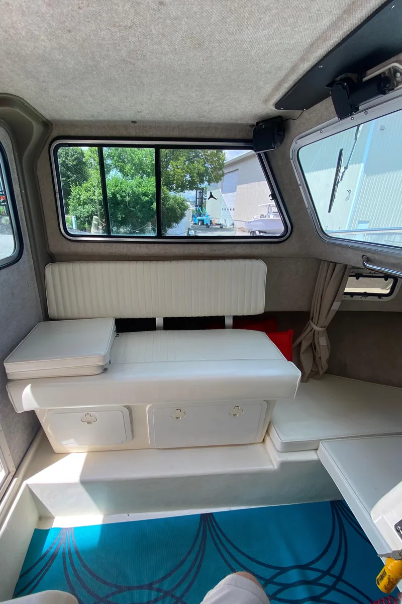 Slide: The Image of Interior of 2009 Parker 2120 Sport Cabin with white seating and windows. - 14