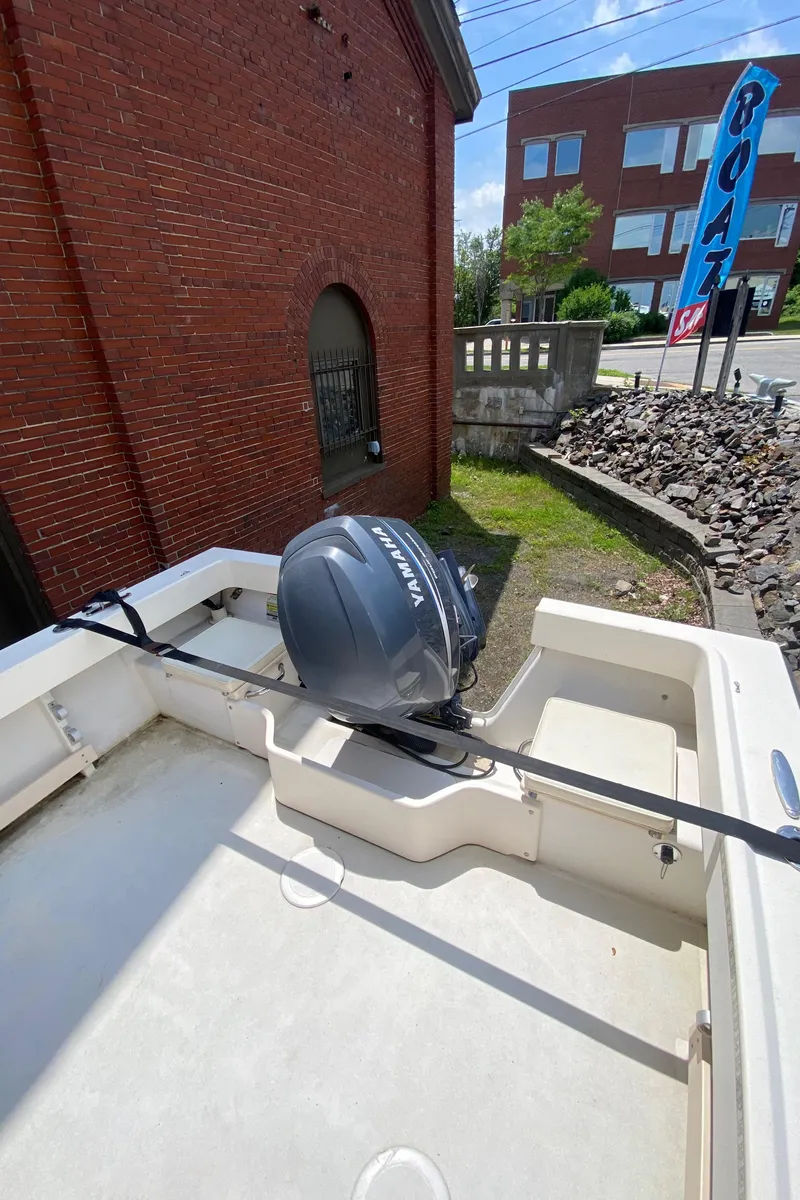 Slide: The Image of 2009 Parker 2120 Sport Cabin boat with Yamaha outboard motor, displayed outdoors. - 6