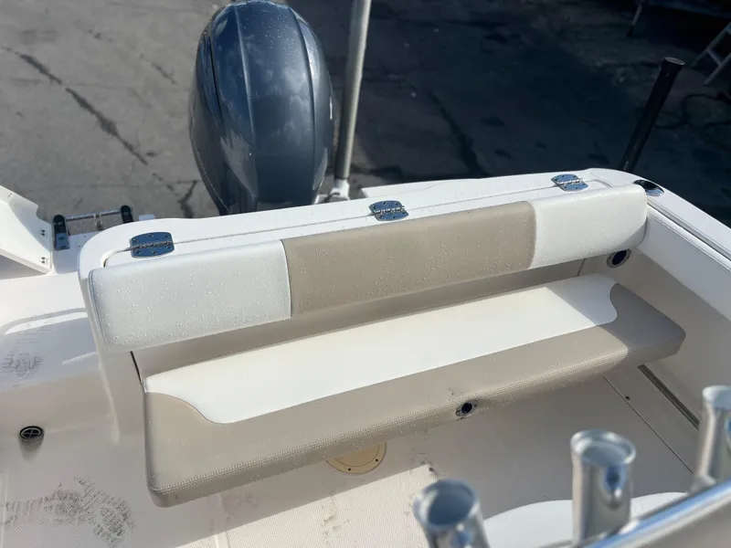 Slide: The Image of 2022 Robalo R222 Center Console boat with cushioned seating and outboard motor. - 11