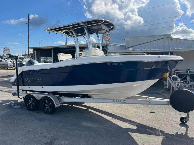 Slide: The Image of 2022 Robalo R222 Center Console boat on trailer at marina. - 2