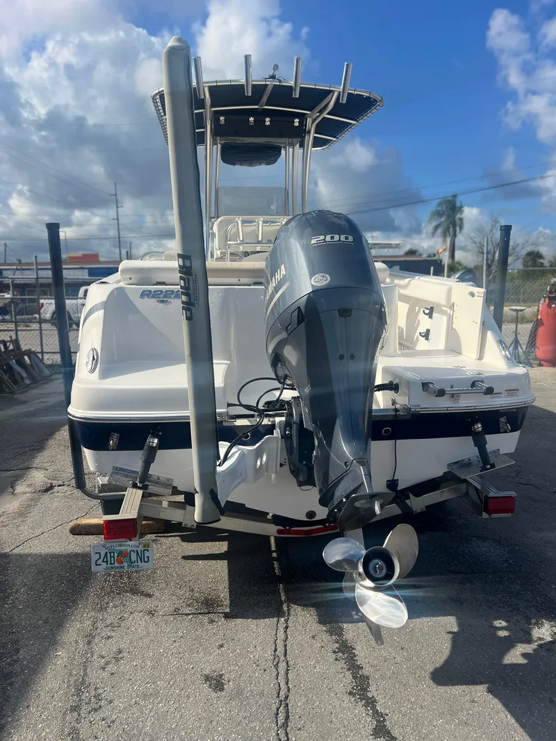 Slide: The Image of 2022 Robalo R222 Center Console boat with Yamaha 200 engine, parked outdoors. - 3