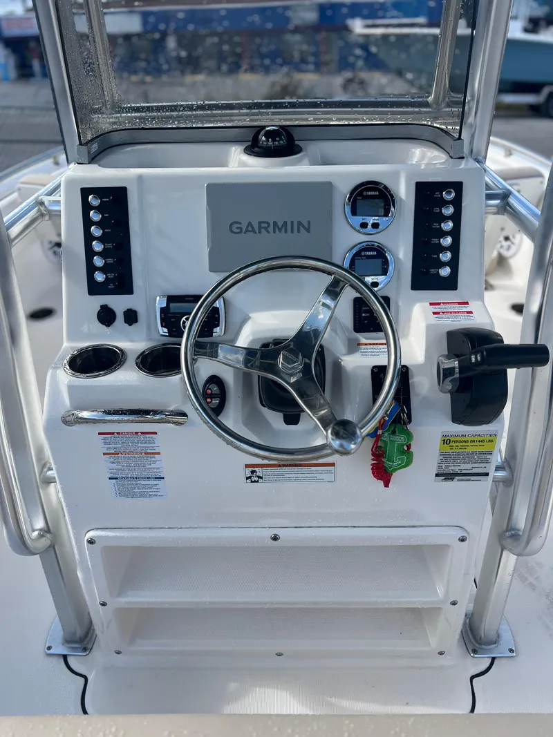Slide: The Image of 2022 Robalo R222 Center Console dashboard with Garmin navigation system and steering wheel. - 4
