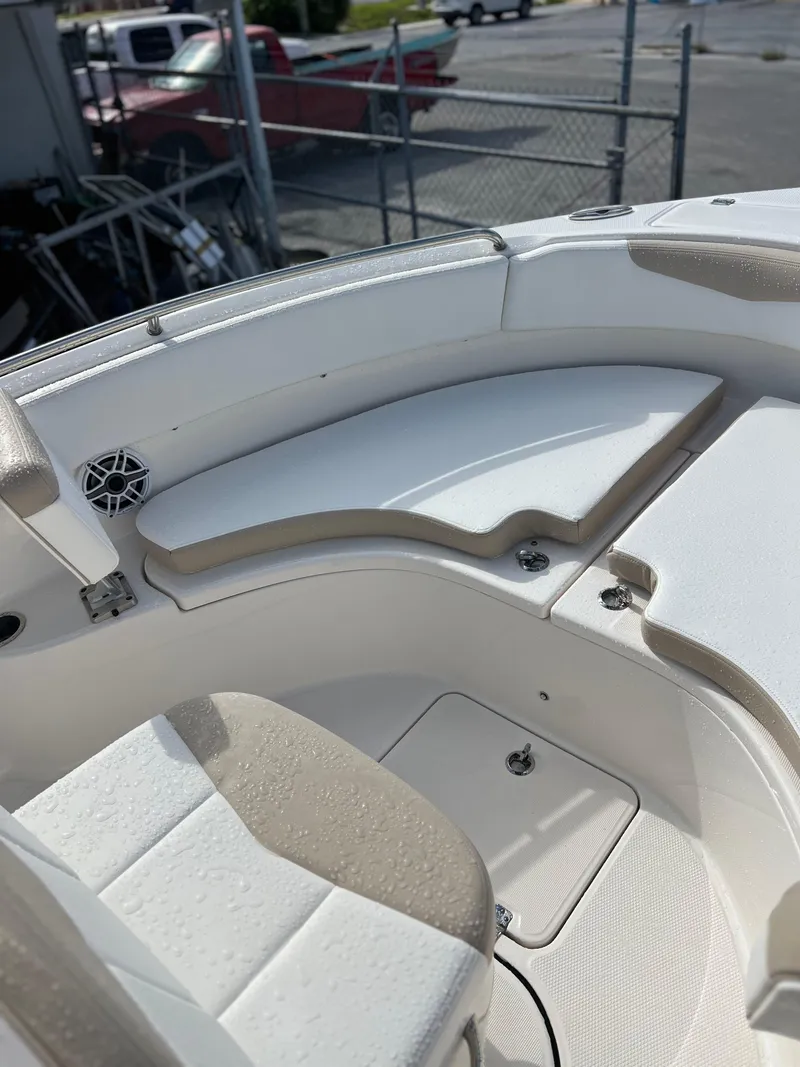 Slide: The Image of 2022 Robalo R222 Center Console boat interior with cushioned seating and storage compartments. - 7