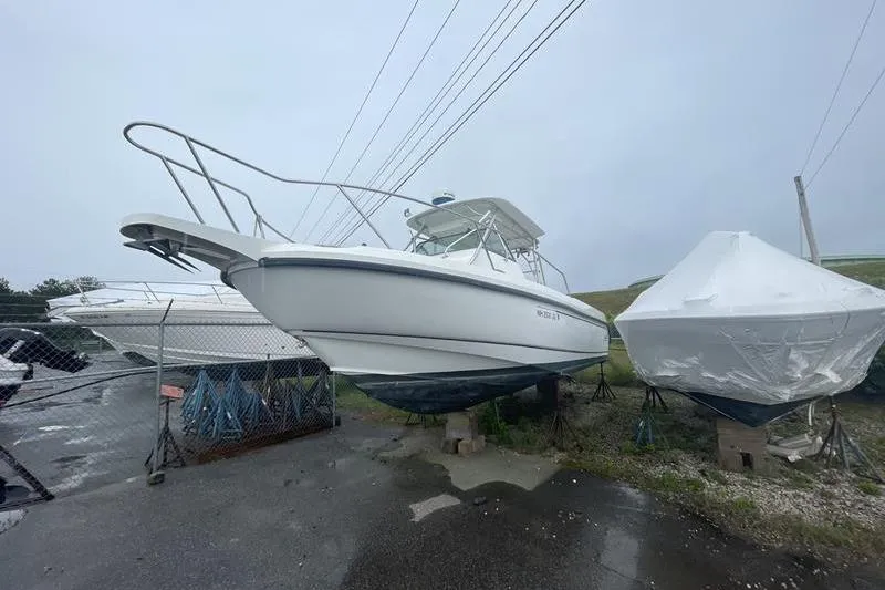 The Image of 2000 Boston Whaler 28 Outrage boat on dry dock, overcast day. - 2