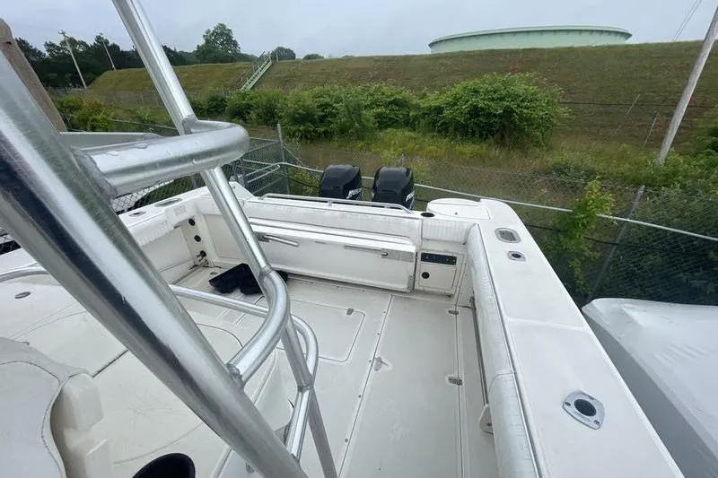 Slide: The Image of 2000 Boston Whaler 28 Outrage boat deck with dual engines, ladder, and spacious seating. - 8