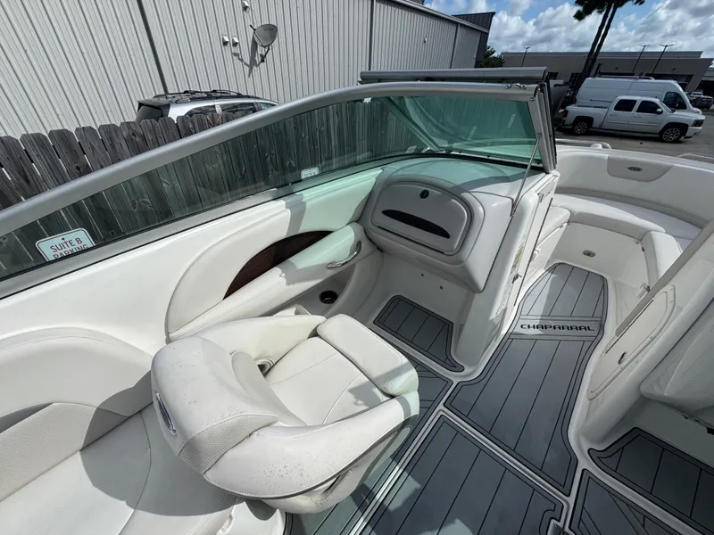 Slide: The Image of 2006 Chaparral 236 SSi boat interior with white seating and gray flooring. - 11