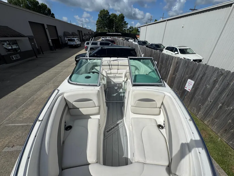 Slide: The Image of 2006 Chaparral 236 SSi boat with white interior, parked outdoors on a sunny day. - 13