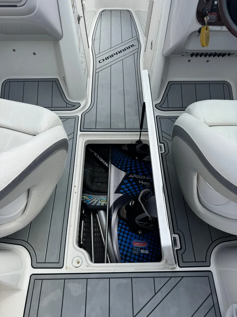 Slide: The Image of 2006 Chaparral 236 SSi boat interior with storage compartment and wakeboard. - 19