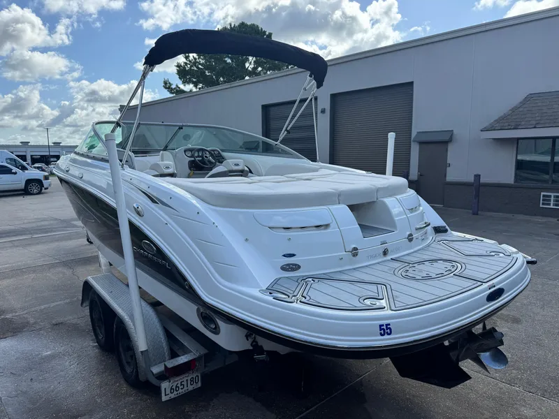 Slide: The Image of 2006 Chaparral 236 SSi boat on trailer, parked outdoors under a cloudy sky. - 3