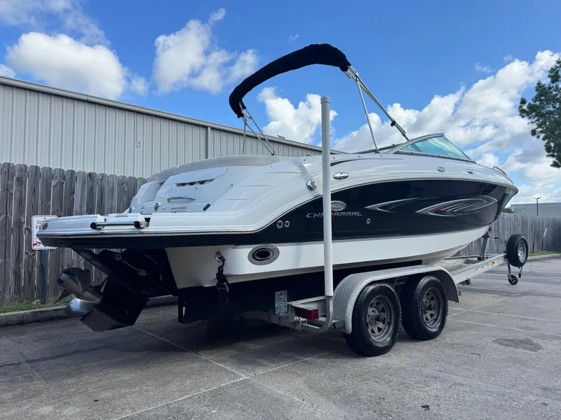 Slide: The Image of 2006 Chaparral 236 SSi boat on trailer, parked outdoors under blue sky. - 4