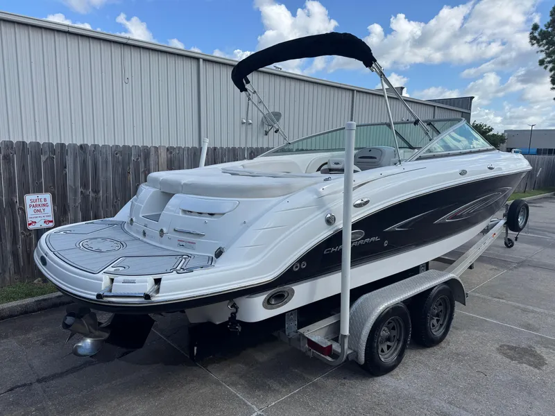 Slide: The Image of 2006 Chaparral 236 SSi boat on trailer, parked outdoors near a fence. - 5