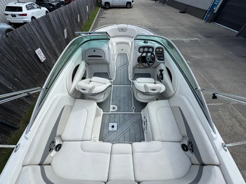Slide: The Image of 2006 Chaparral 236 SSi boat interior with white seating and modern dashboard. - 9