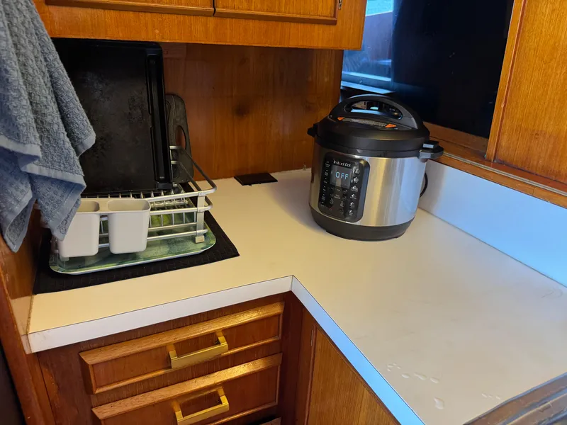 Slide: The Image of Kitchen area in 1981 Bertram 58 Flybridge Motor Yacht with pressure cooker and dish rack. - 13