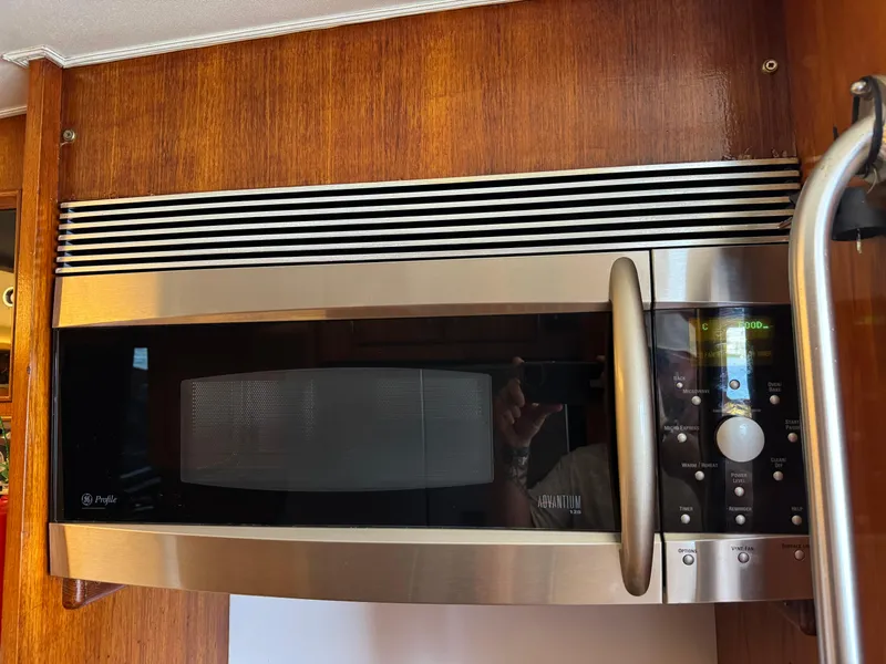 Slide: The Image of Microwave oven in 1981 Bertram 58 Flybridge Motor Yacht kitchen, wood paneling background. - 15