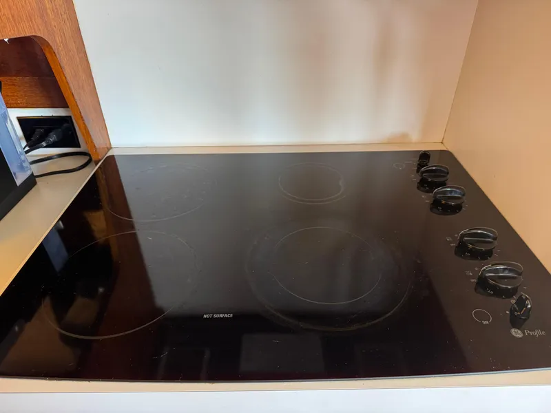 Slide: The Image of Glass cooktop with control knobs on a 1981 Bertram 58 Flybridge Motor Yacht. - 16