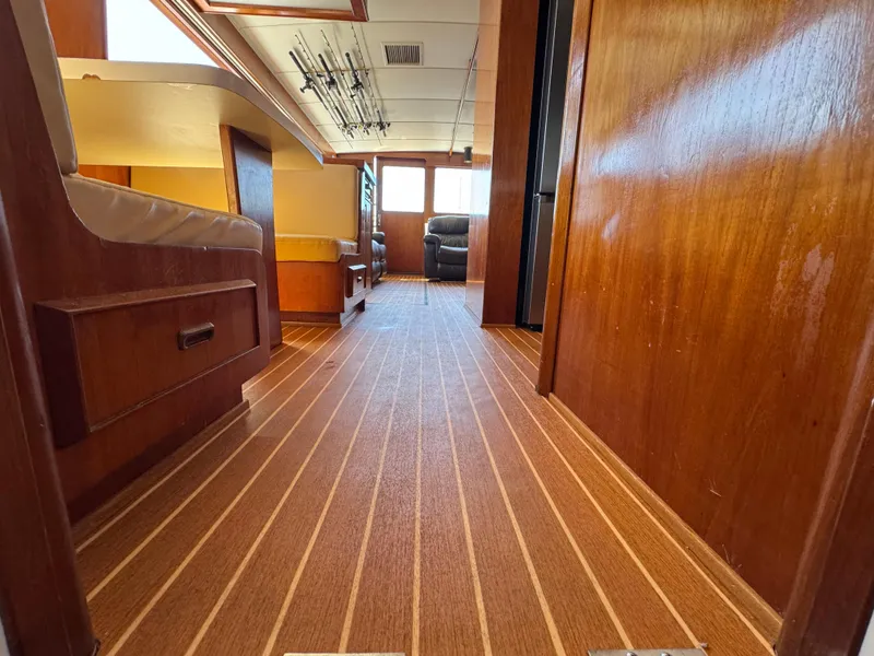 Slide: The Image of 1981 Bertram 58 Flybridge Motor Yacht interior with wood paneling and striped flooring. - 17