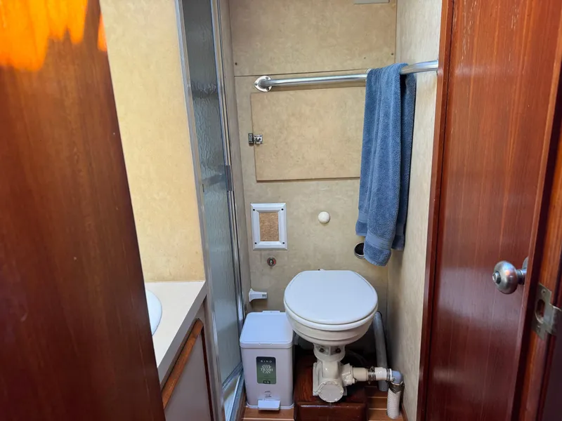 Slide: The Image of Bathroom interior of 1981 Bertram 58 Flybridge Motor Yacht with toilet and towel. - 28