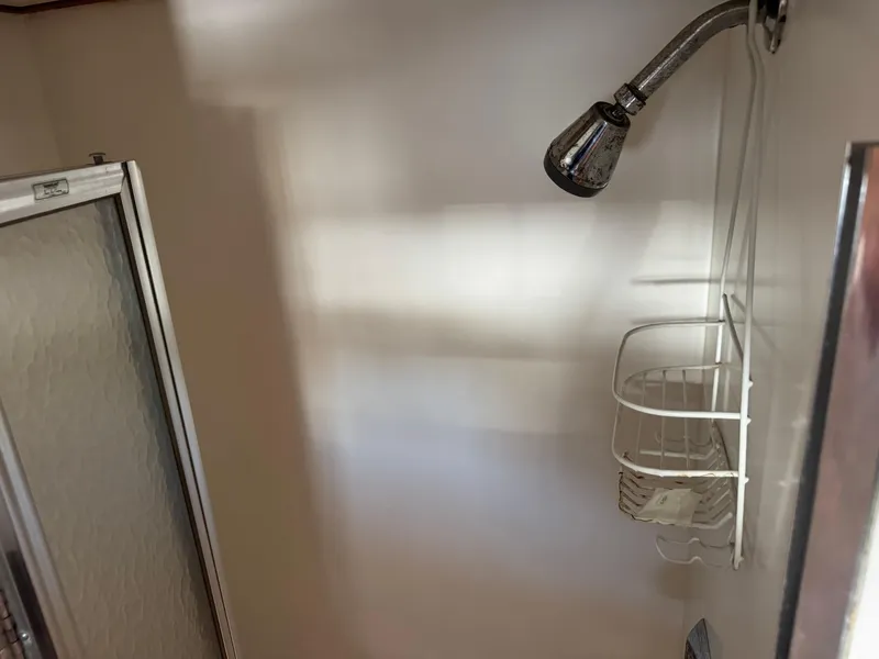 Slide: The Image of Shower area in 1981 Bertram 58 Flybridge Motor Yacht with metal showerhead and caddy. - 29