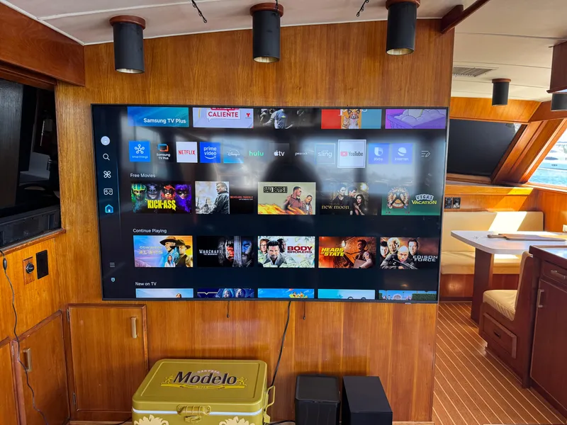 Slide: The Image of Large TV screen in 1981 Bertram 58 Flybridge Motor Yacht interior with streaming apps displayed. - 3