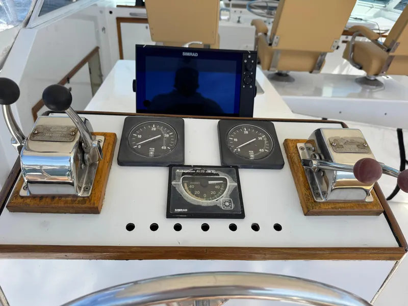 Slide: The Image of Control panel of a 1981 Bertram 58 Flybridge Motor Yacht with gauges and levers. - 35