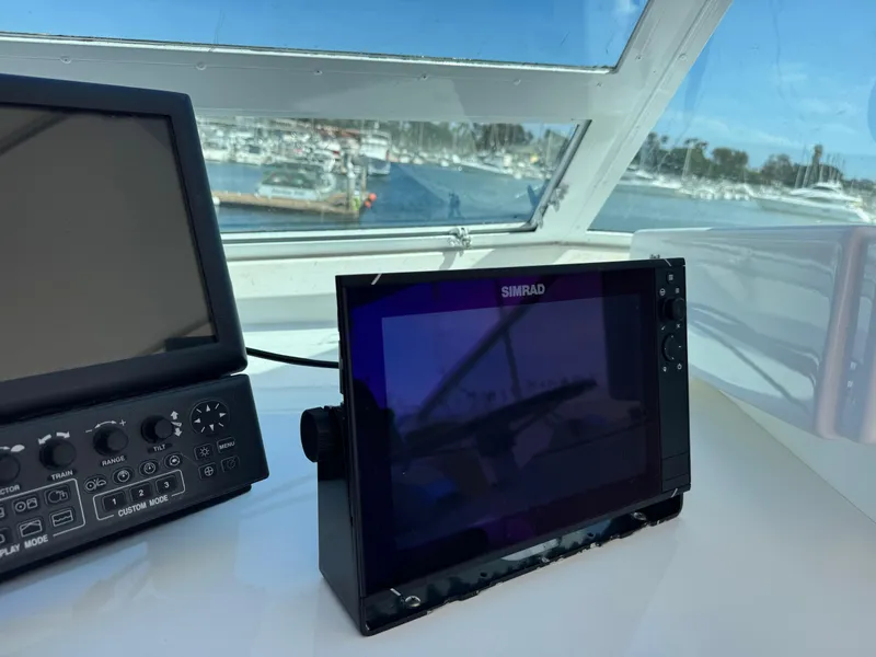 Slide: The Image of Navigation equipment on 1981 Bertram 58 Flybridge Motor Yacht, with marina view. - 38
