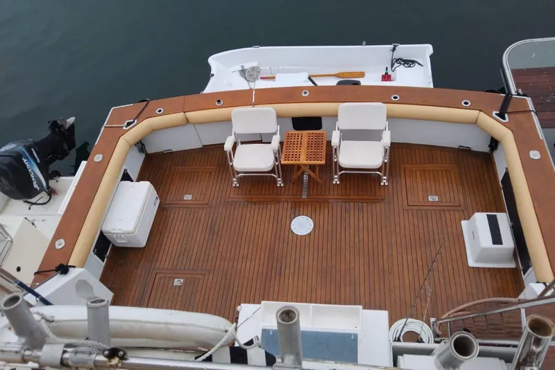 Slide: The Image of 1981 Bertram 58 Flybridge Motor Yacht deck with seating and wooden flooring. - 40
