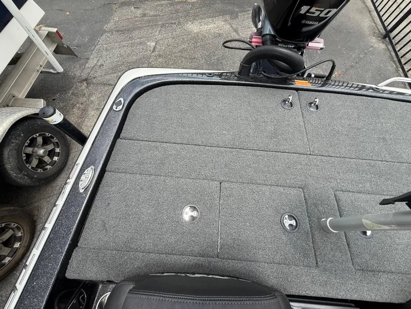 Slide: The Image of 2022 Skeeter ZX 150 boat deck with Yamaha 150 engine, featuring gray carpet and storage compartments. - 10