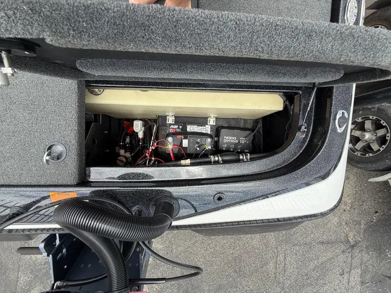 Slide: The Image of 2022 Skeeter ZX 150 boat battery compartment with wiring and components visible. - 13