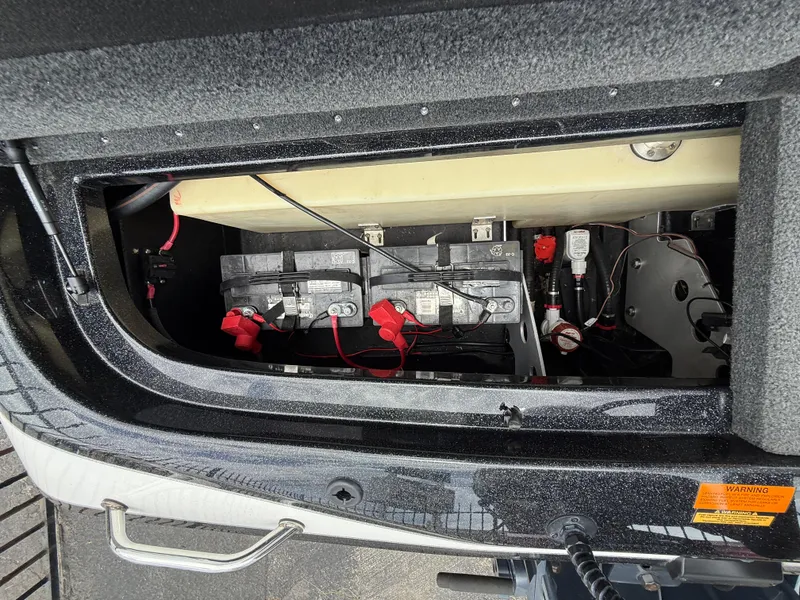 Slide: The Image of 2022 Skeeter ZX 150 boat battery compartment with wiring and connections. - 14