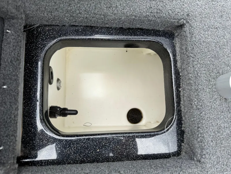 Slide: The Image of Livewell compartment in a 2022 Skeeter ZX 150 boat, featuring a clean interior. - 16