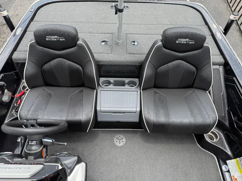 Slide: The Image of 2022 Skeeter ZX 150 boat interior with dual black seats and steering wheel. - 19