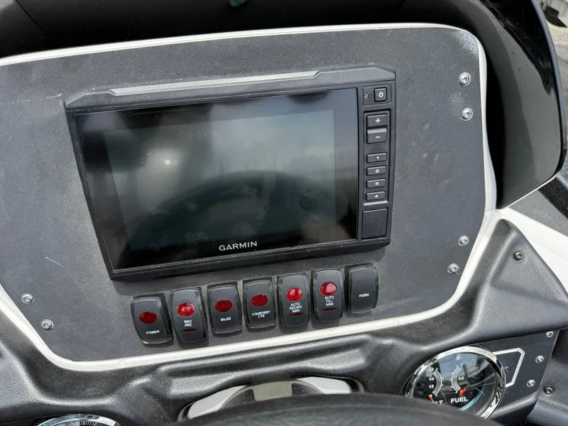 Slide: The Image of Dashboard of 2022 Skeeter ZX 150 with Garmin display and control switches. - 21