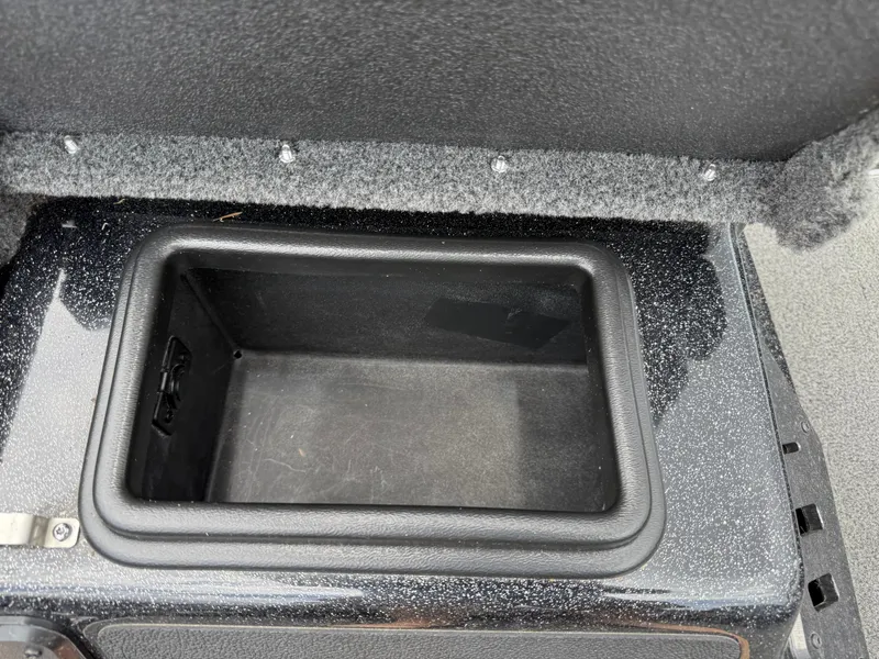 Slide: The Image of Open storage compartment in 2022 Skeeter ZX 150 boat, featuring carpeted interior and secure lid. - 25