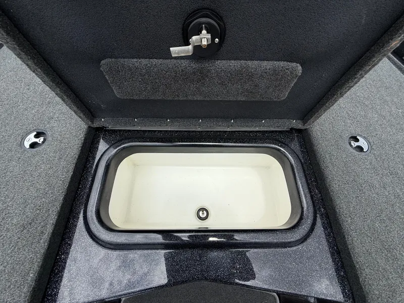 Slide: The Image of 2022 Skeeter ZX 150 boat storage compartment with open lid, showcasing interior space. - 27
