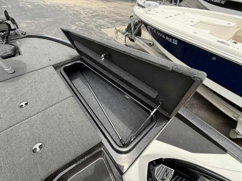 Slide: The Image of 2022 Skeeter ZX 150 boat storage compartment open, showcasing interior space. - 28
