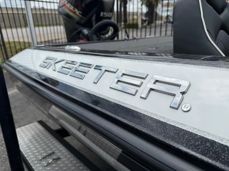Slide: The Image of 2022 Skeeter ZX 150 boat with sleek design and metallic logo detail. - 3