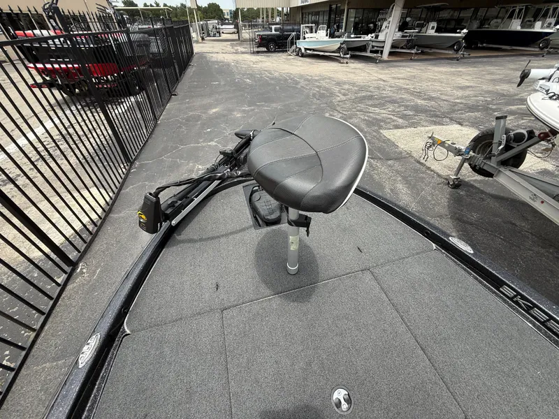 Slide: The Image of 2022 Skeeter ZX 150 boat deck with seat and trolling motor in a dealership lot. - 32