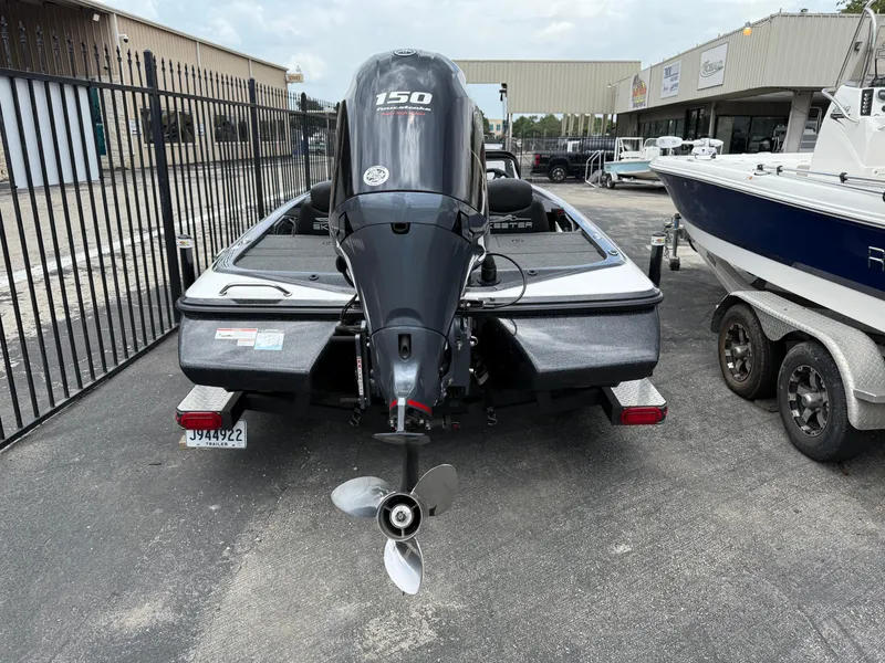 Slide: The Image of 2022 Skeeter ZX 150 boat with powerful outboard motor, parked in a dealership lot. - 5