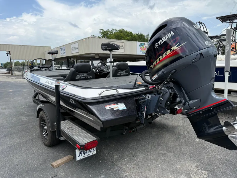 Slide: The Image of 2022 Skeeter ZX 150 boat with Yamaha engine, parked on a trailer in a dealership lot. - 6