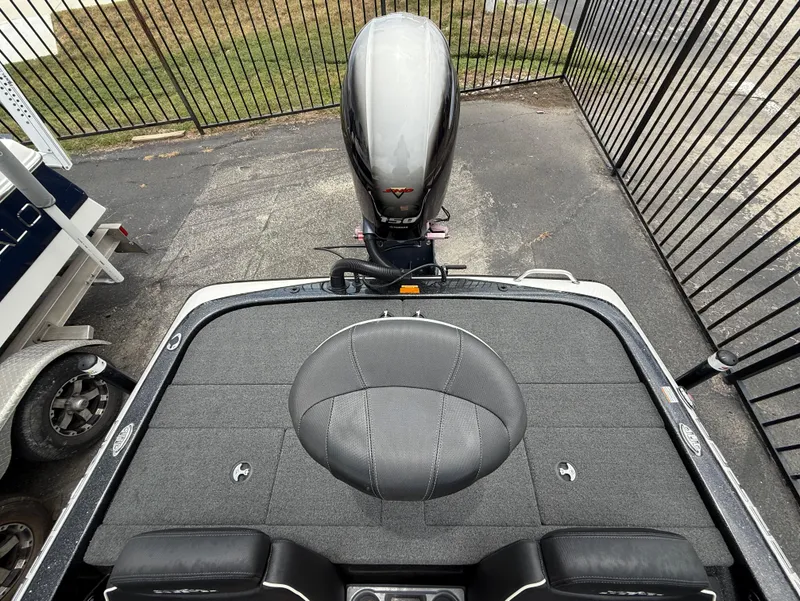 Slide: The Image of 2022 Skeeter ZX 150 boat with motor, viewed from above, parked near a fence. - 9