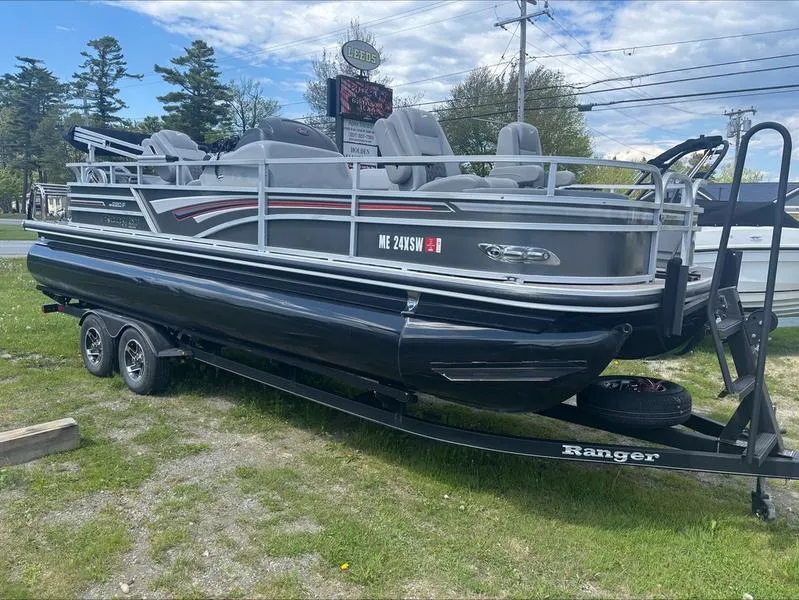 The Image of 2022 Ranger 220 F pontoon boat on trailer, parked outdoors. - 1