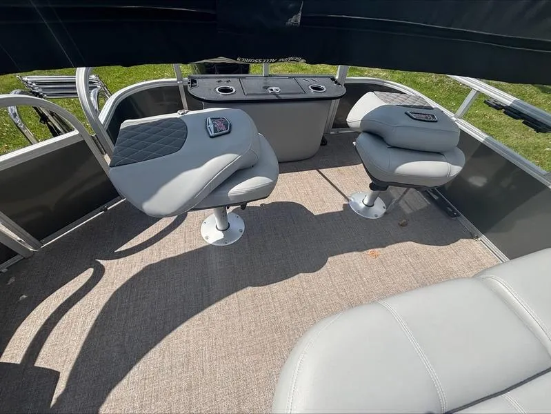 Slide: The Image of 2022 Ranger 220 F boat interior with gray seating and cup holders. - 11