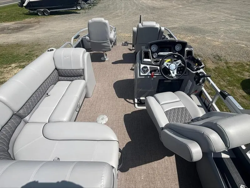 Slide: The Image of 2022 Ranger 220 F pontoon boat interior with plush seating and modern dashboard. - 14