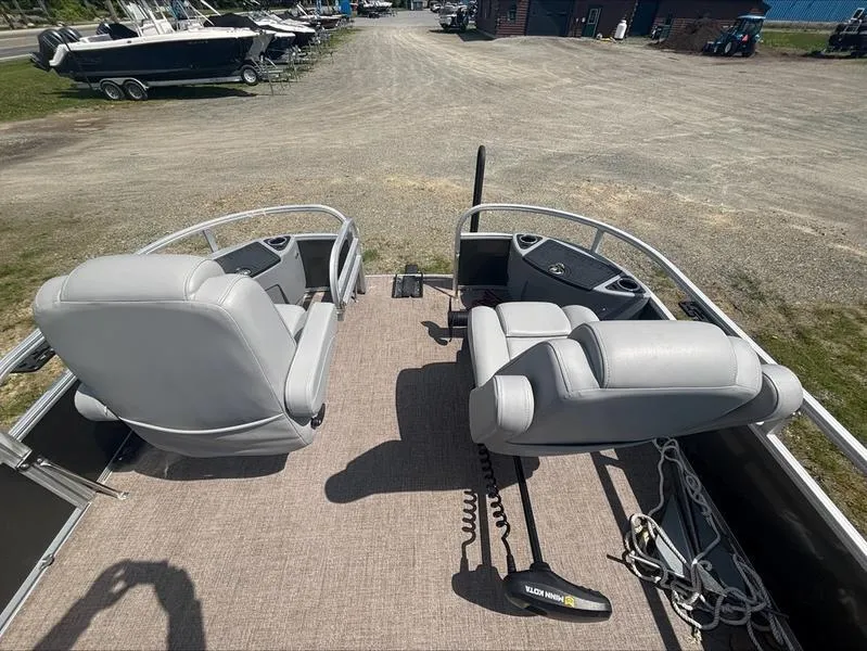 Slide: The Image of 2022 Ranger 220 F boat interior with two gray seats and control panel. - 15