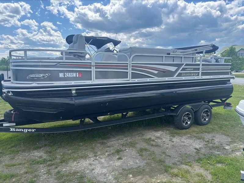 Slide: The Image of 2022 Ranger 220 F pontoon boat on trailer under cloudy sky. - 8