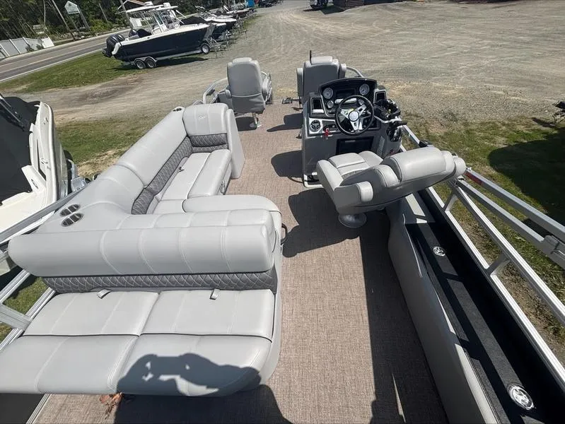 Slide: The Image of 2022 Ranger 220 F pontoon boat interior with gray seating and steering console. - 9