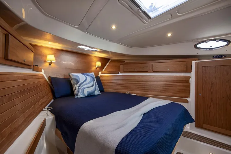 Slide: The Image of Luxurious cabin interior of 2026 Back Cove 412 yacht with wood paneling and cozy bedding. - 12
